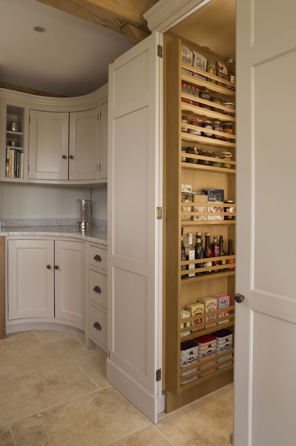 Hand-painted tall walk-in larder with spice racks.